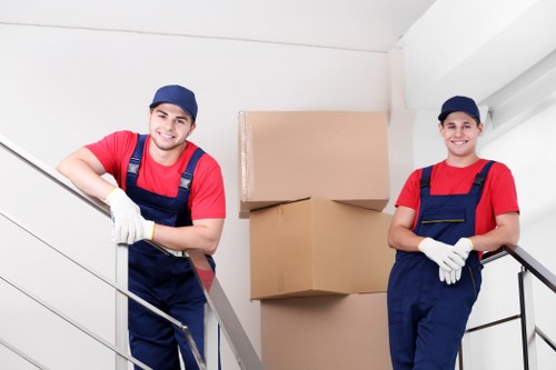 Mover carrying furniture carefully with safe lifting practice