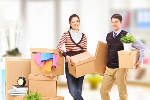 House movers assisting with boxes and furniture in a residential move