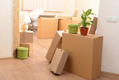 Local movers handling household furniture in a North Sheen property